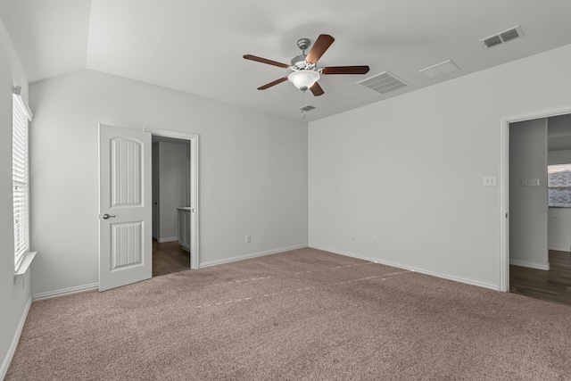 unfurnished bedroom with ceiling fan, carpet floors, and lofted ceiling