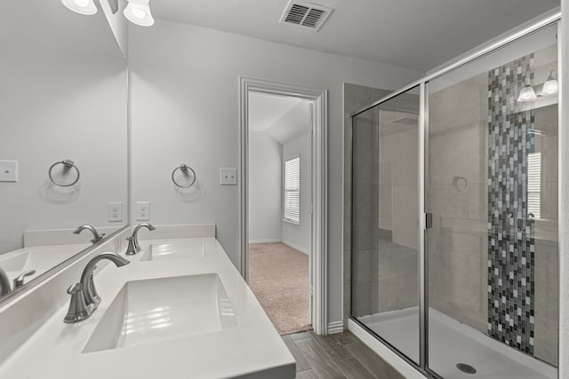 bathroom featuring vanity and a shower with shower door