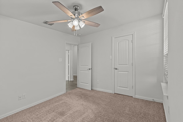 unfurnished bedroom featuring light carpet and ceiling fan