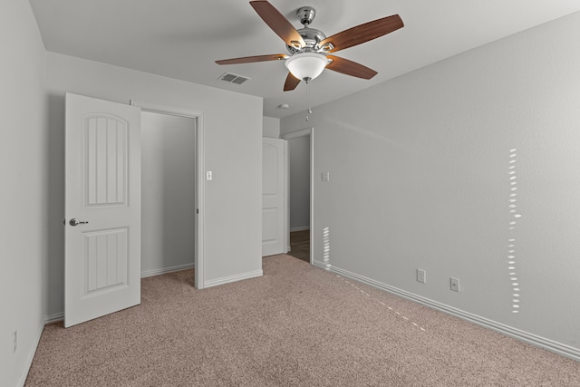 unfurnished bedroom featuring ceiling fan, a closet, and carpet