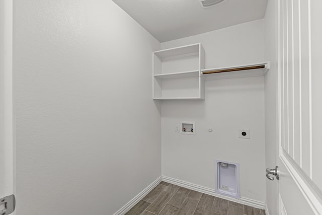 laundry area with hookup for a washing machine, gas dryer hookup, dark hardwood / wood-style flooring, and hookup for an electric dryer