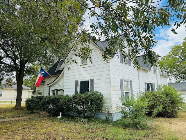 view of property exterior with a lawn