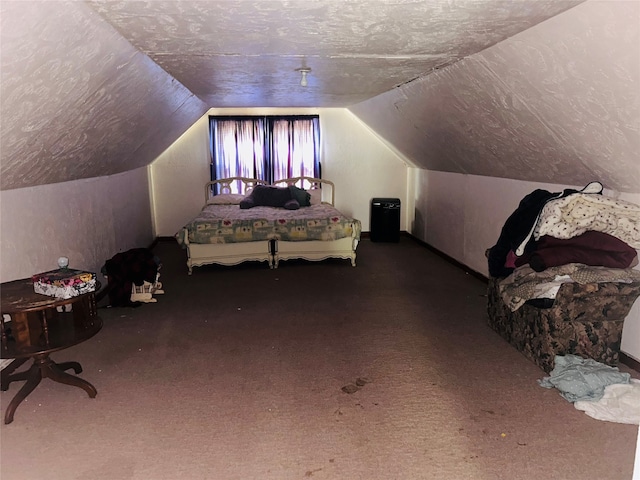 bedroom with lofted ceiling and a textured ceiling