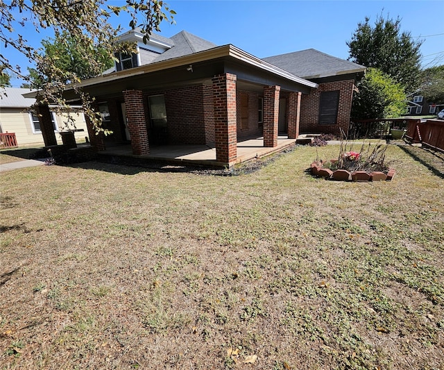 view of home's exterior with a lawn and a patio area