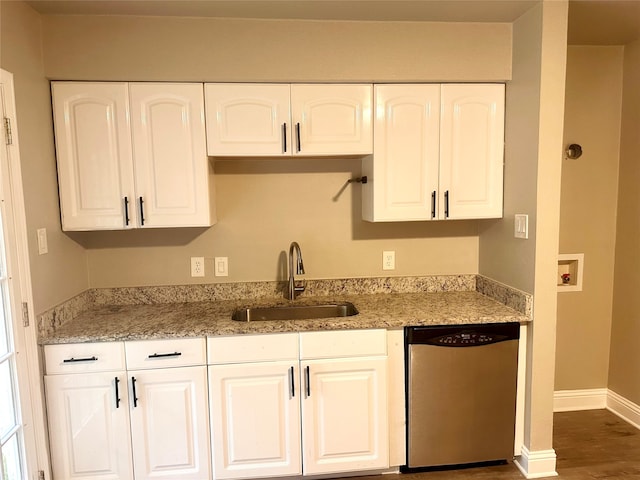 kitchen featuring dishwasher, dark hardwood / wood-style floors, sink, white cabinetry, and light stone countertops