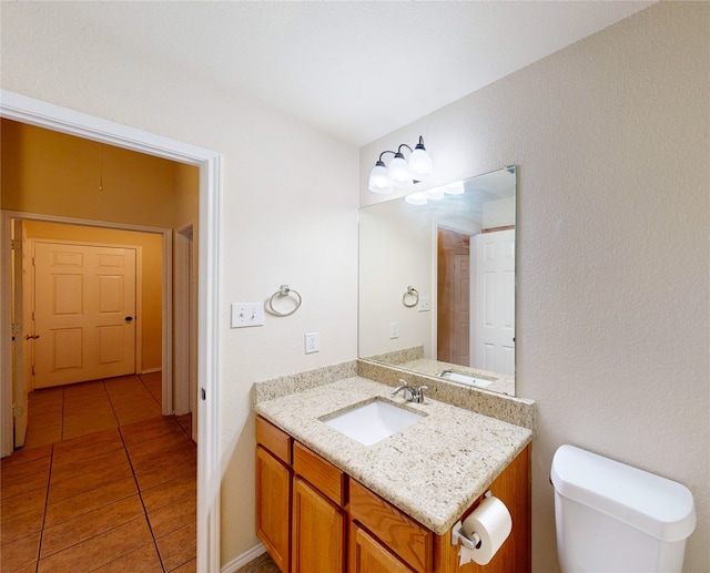 bathroom with vanity, toilet, and tile patterned floors