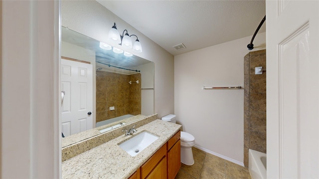 full bathroom featuring vanity, tiled shower / bath combo, and toilet