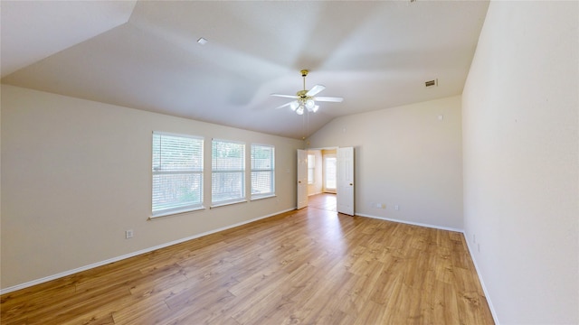 empty room featuring light wood-type flooring, vaulted ceiling, and ceiling fan