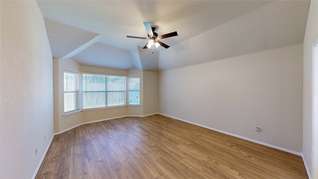 spare room with lofted ceiling, light hardwood / wood-style floors, and ceiling fan