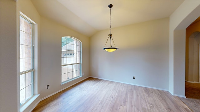 unfurnished room featuring light hardwood / wood-style flooring and vaulted ceiling