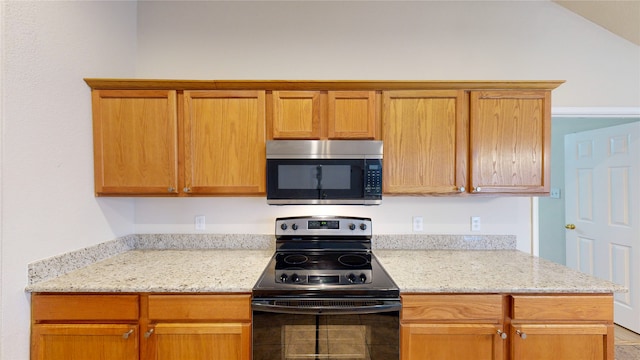 kitchen with light stone counters and black electric range