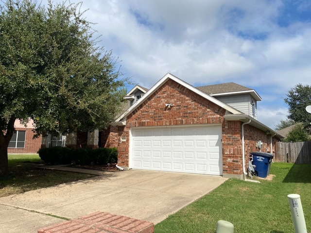 view of front of property with a front yard and a garage