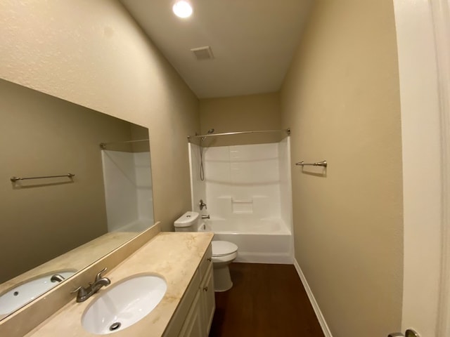 full bathroom with hardwood / wood-style floors, shower / bath combination, vanity, and toilet