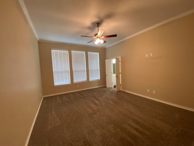 carpeted spare room featuring ceiling fan and crown molding