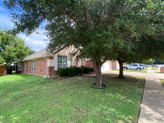 exterior space featuring a lawn and a garage