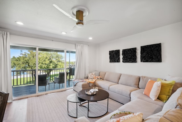 living room with ceiling fan and light hardwood / wood-style floors