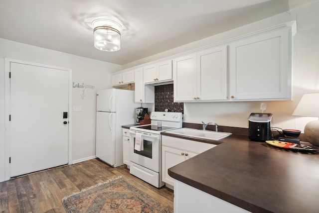 kitchen with white cabinetry, sink, white appliances, and dark hardwood / wood-style flooring