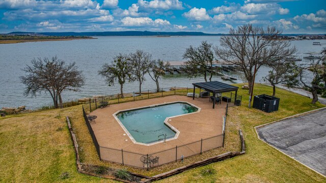 view of swimming pool with a water and mountain view, a yard, and a gazebo