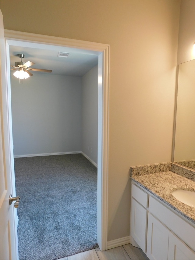 bathroom featuring ceiling fan and vanity