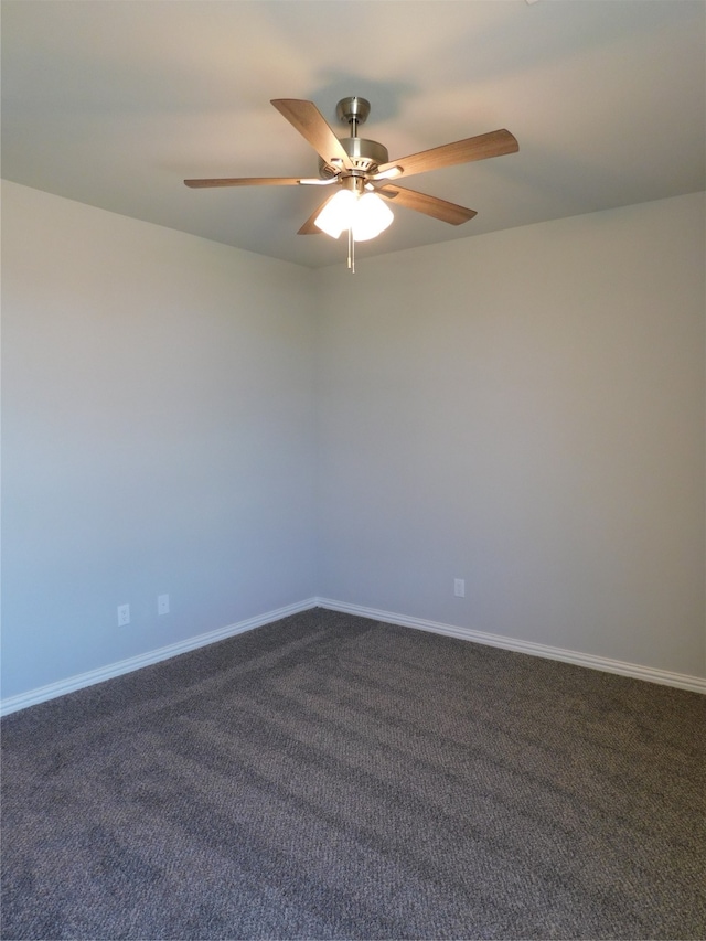 empty room with ceiling fan and dark colored carpet