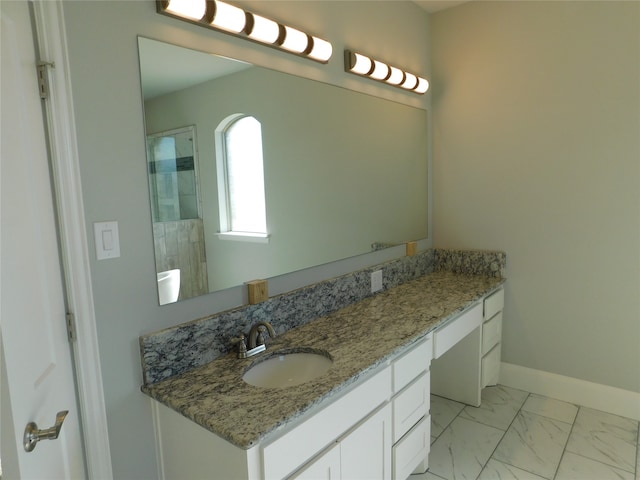 bathroom with walk in shower and vanity