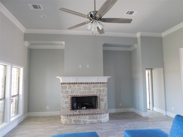 unfurnished living room with ceiling fan, light hardwood / wood-style flooring, a fireplace, and a healthy amount of sunlight