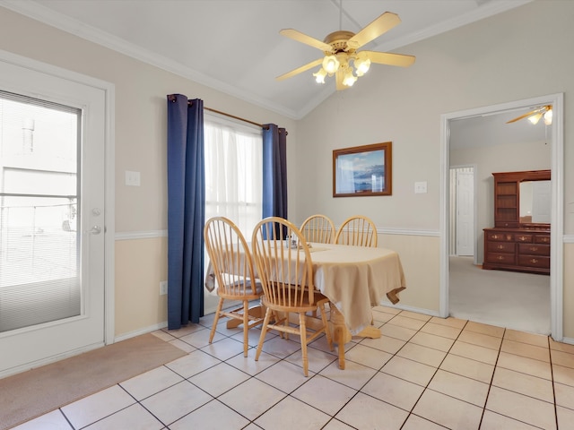 tiled dining area with crown molding, vaulted ceiling, ceiling fan, and a wealth of natural light