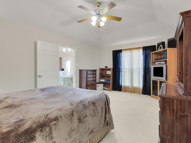 carpeted bedroom with multiple windows and ceiling fan