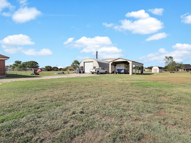 view of yard with a storage shed and a carport