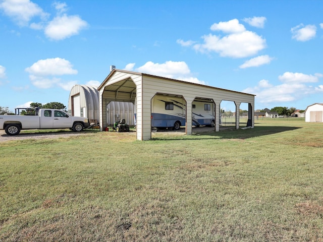 view of outbuilding featuring a lawn and a carport