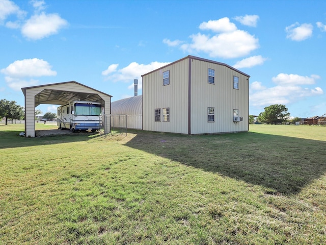 view of outdoor structure with a lawn and a carport