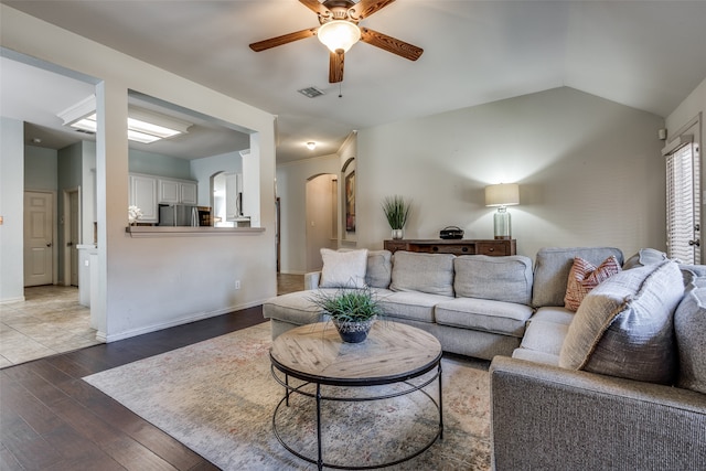 living room featuring vaulted ceiling, hardwood / wood-style flooring, and ceiling fan