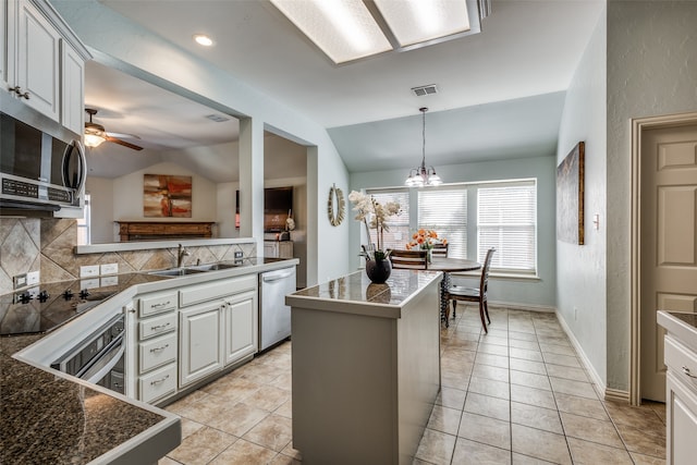 kitchen featuring lofted ceiling, tasteful backsplash, stainless steel appliances, and sink