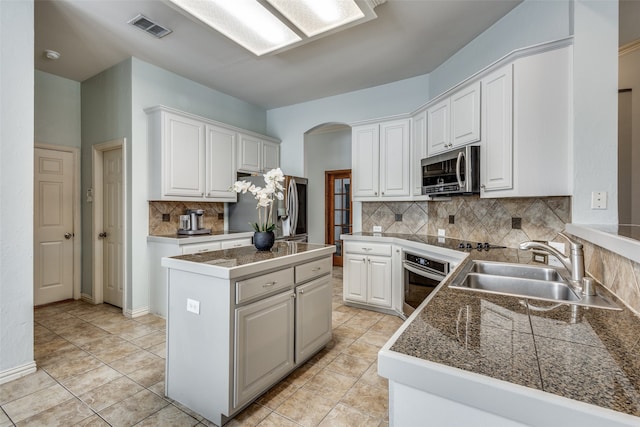 kitchen featuring tasteful backsplash, appliances with stainless steel finishes, sink, and white cabinets