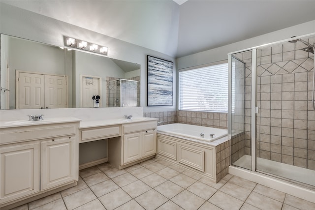 bathroom with vanity, vaulted ceiling, independent shower and bath, and tile patterned flooring