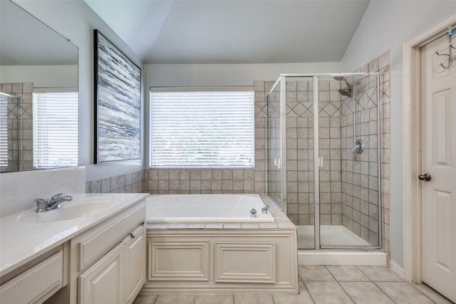 bathroom with lofted ceiling, shower with separate bathtub, and a wealth of natural light