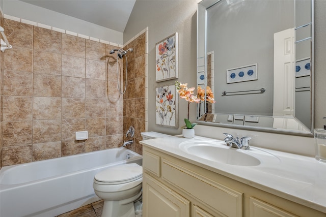 full bathroom featuring tile patterned floors, toilet, vaulted ceiling, tiled shower / bath combo, and vanity