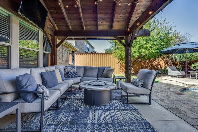 view of patio featuring an outdoor living space with a fire pit