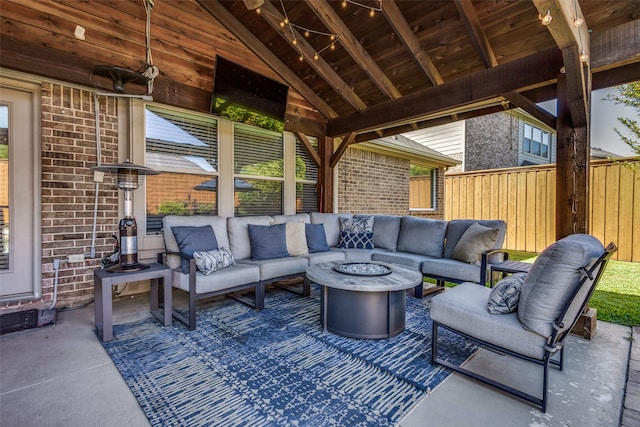 view of patio / terrace with an outdoor living space with a fire pit