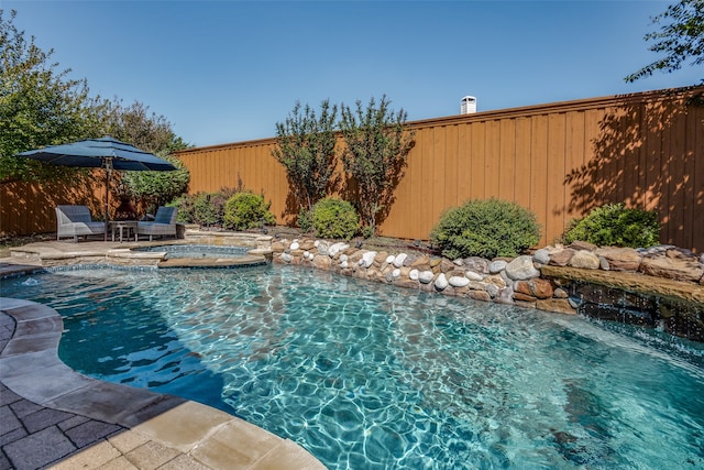 view of pool with an in ground hot tub