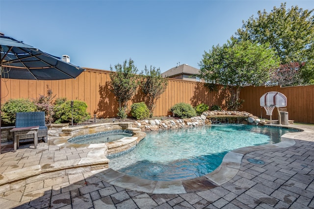 view of swimming pool with an in ground hot tub and a patio