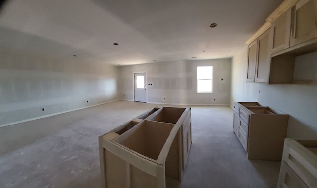 kitchen with light brown cabinetry and a center island