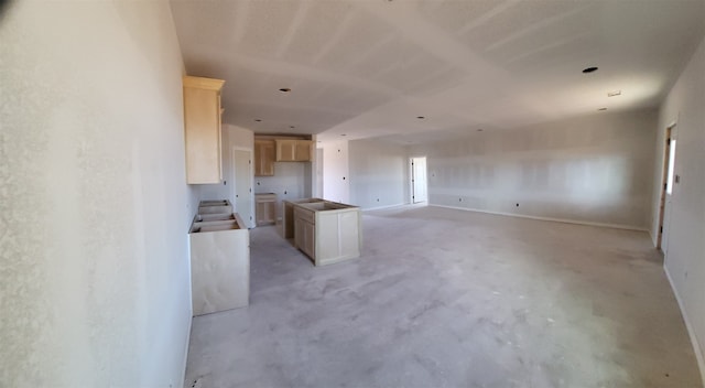 kitchen with a center island and light brown cabinets