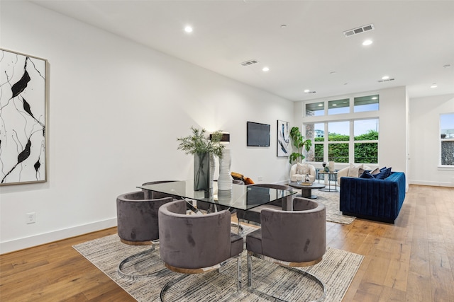 dining space with light hardwood / wood-style floors