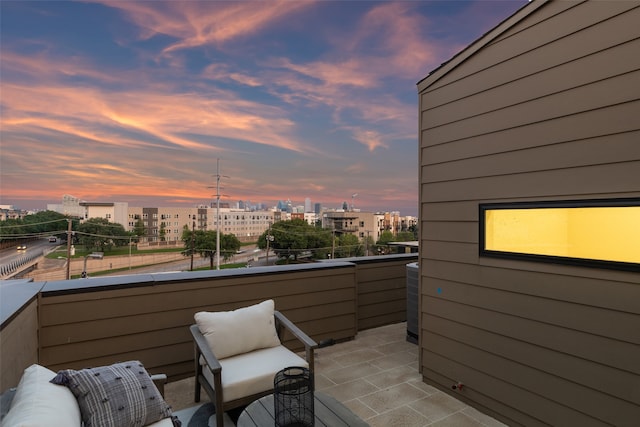 patio terrace at dusk with a balcony