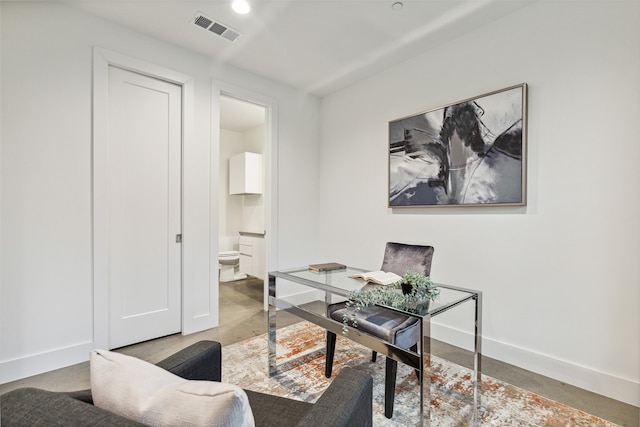 office area featuring concrete flooring