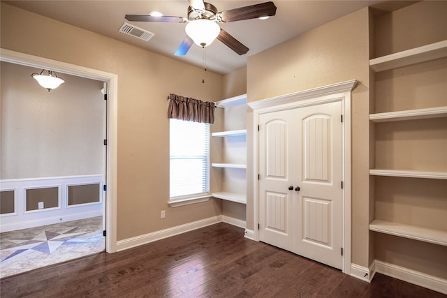 unfurnished bedroom with ceiling fan and dark hardwood / wood-style floors