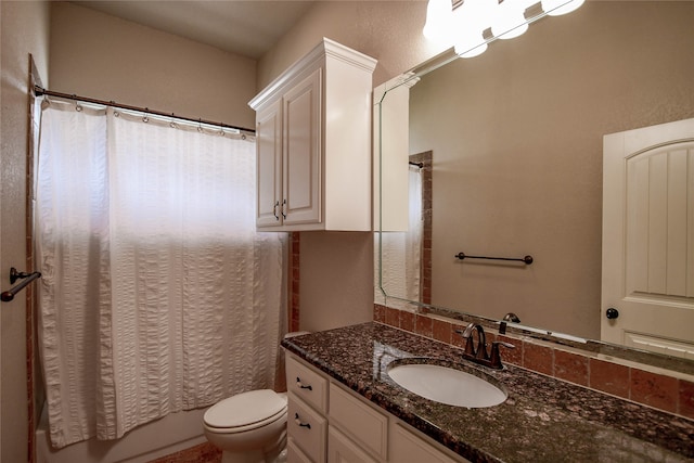 full bathroom with vanity, shower / tub combo, and toilet