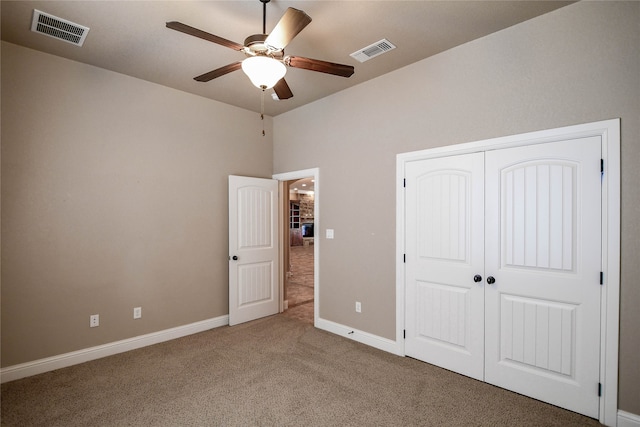 unfurnished bedroom with ceiling fan, a closet, and carpet flooring