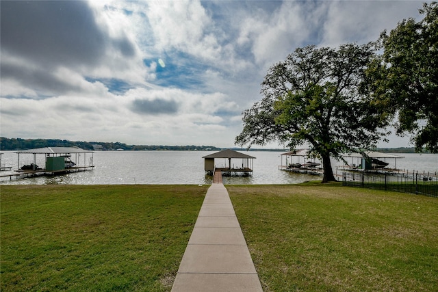 dock area featuring a lawn and a water view